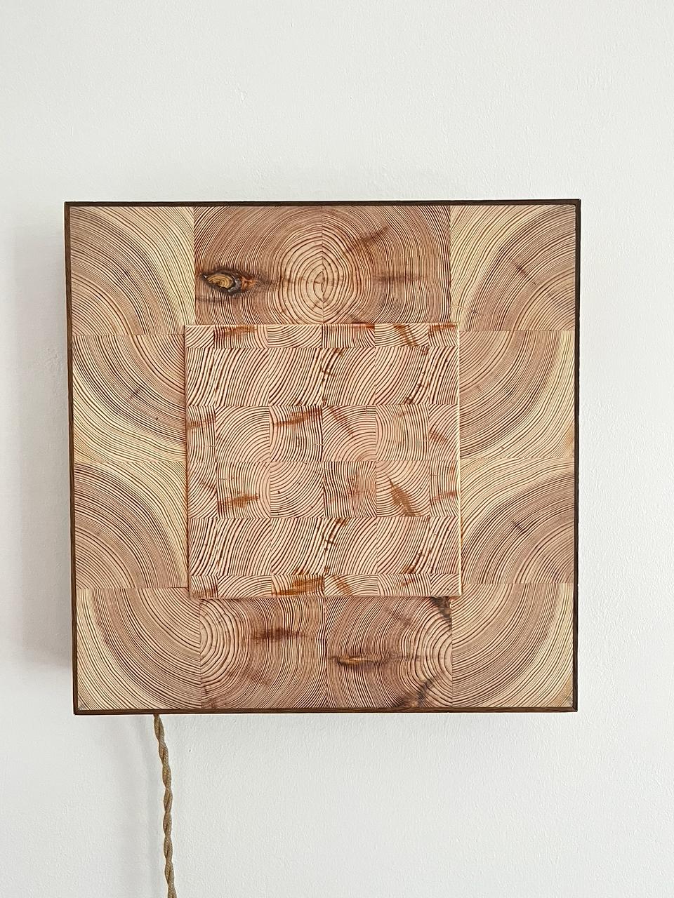 PULSE detail — wooden face with carved center panel and braided cord