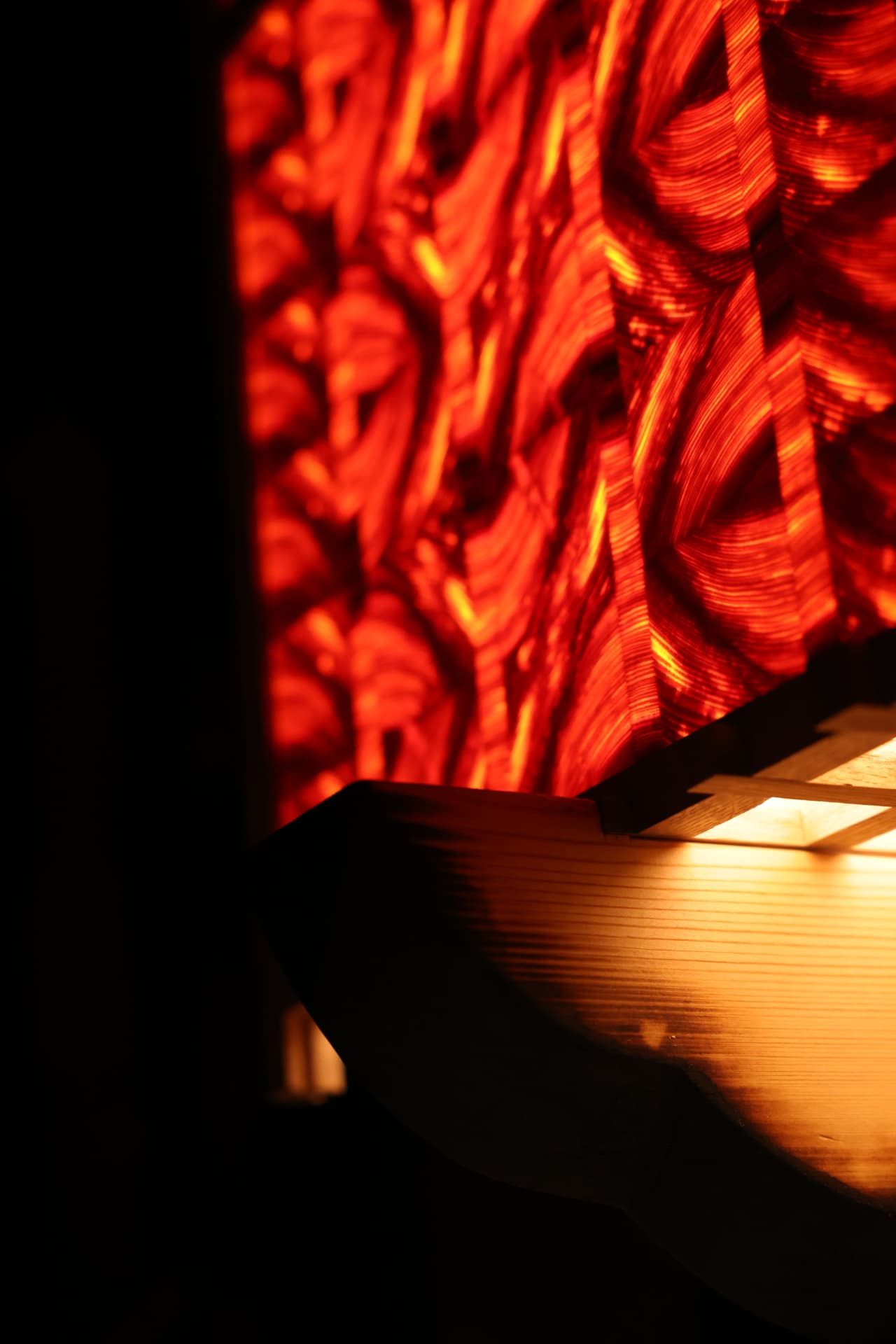 PASSAGE detail — illuminated threshold plane meeting the timber grid