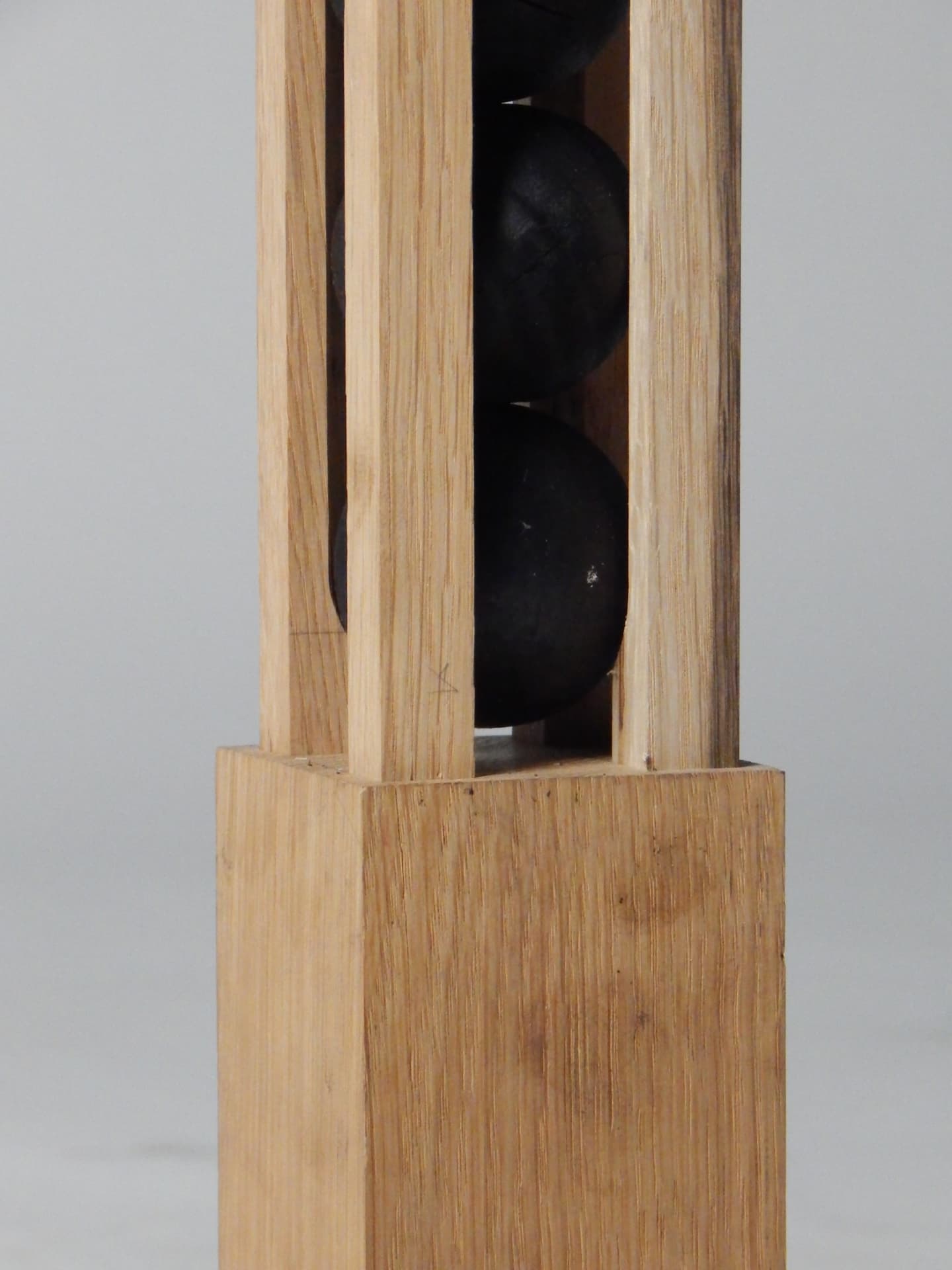 RIFT detail — dark spheres resting within the raw wooden frame