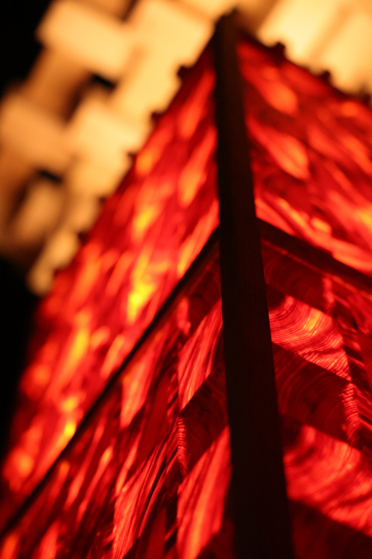 PASSAGE detail — a dark vertical edge dividing two glowing wood surfaces